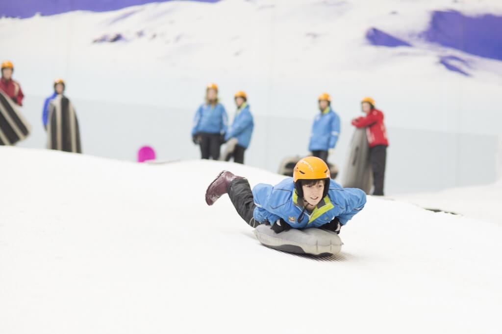 day trip round up promotional picture of sledding fun at chill factore