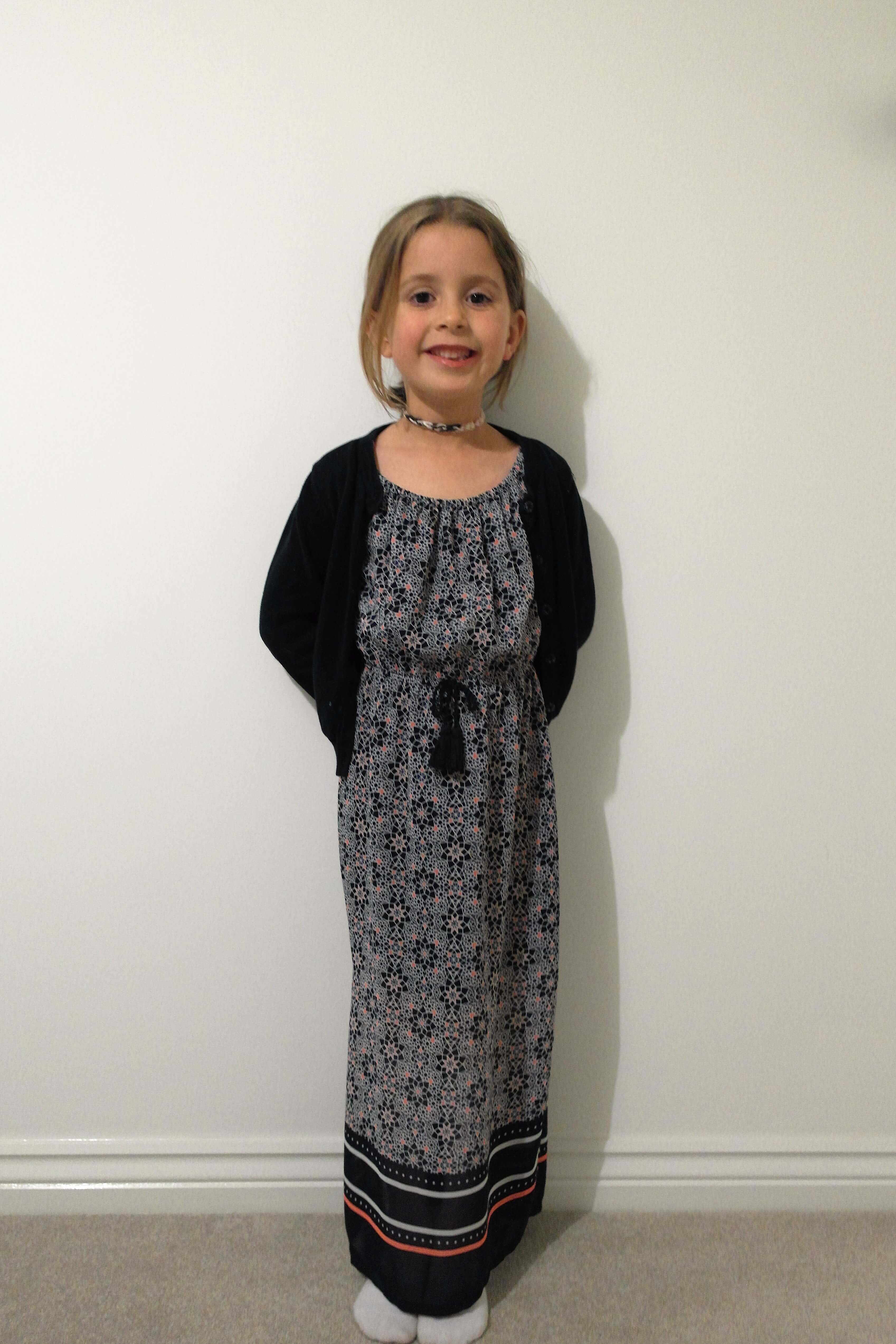 beg's style wearing a black maxi dress