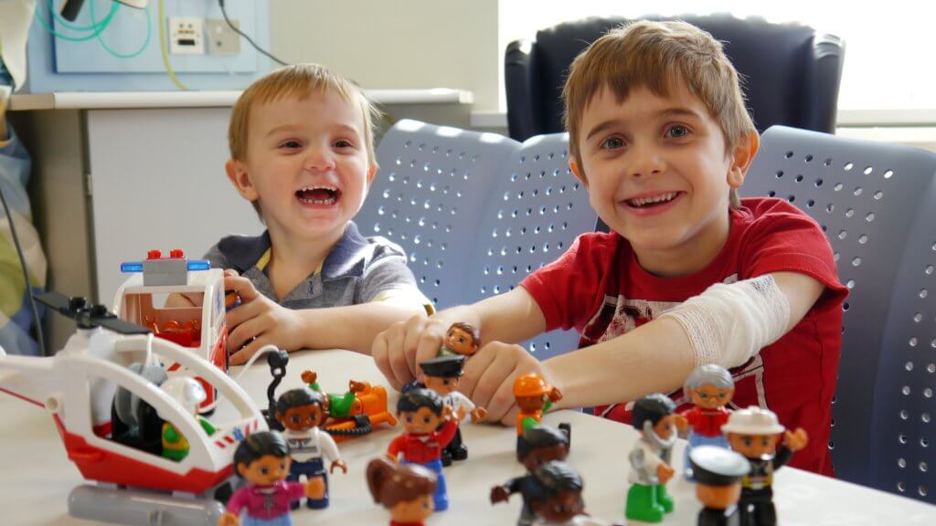 donate to alder hey campaign two boys playing with toys in hospital environment