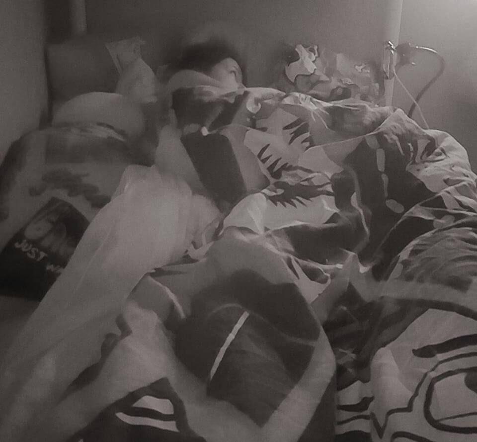 easy bedtime routine for kids picture of girl lying in bed watching her phone
