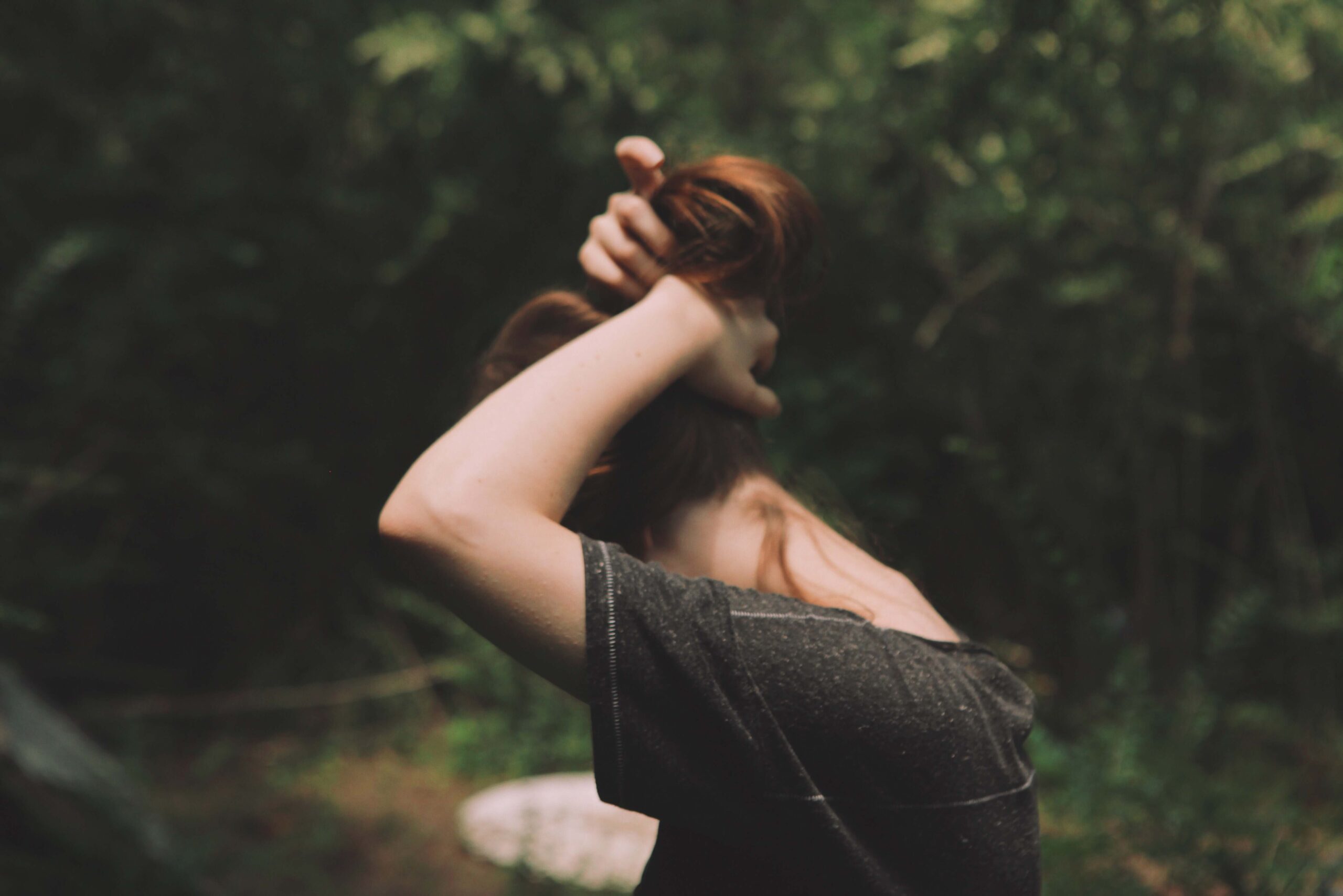 confronting my hair demons picture of a girl putting her hair up