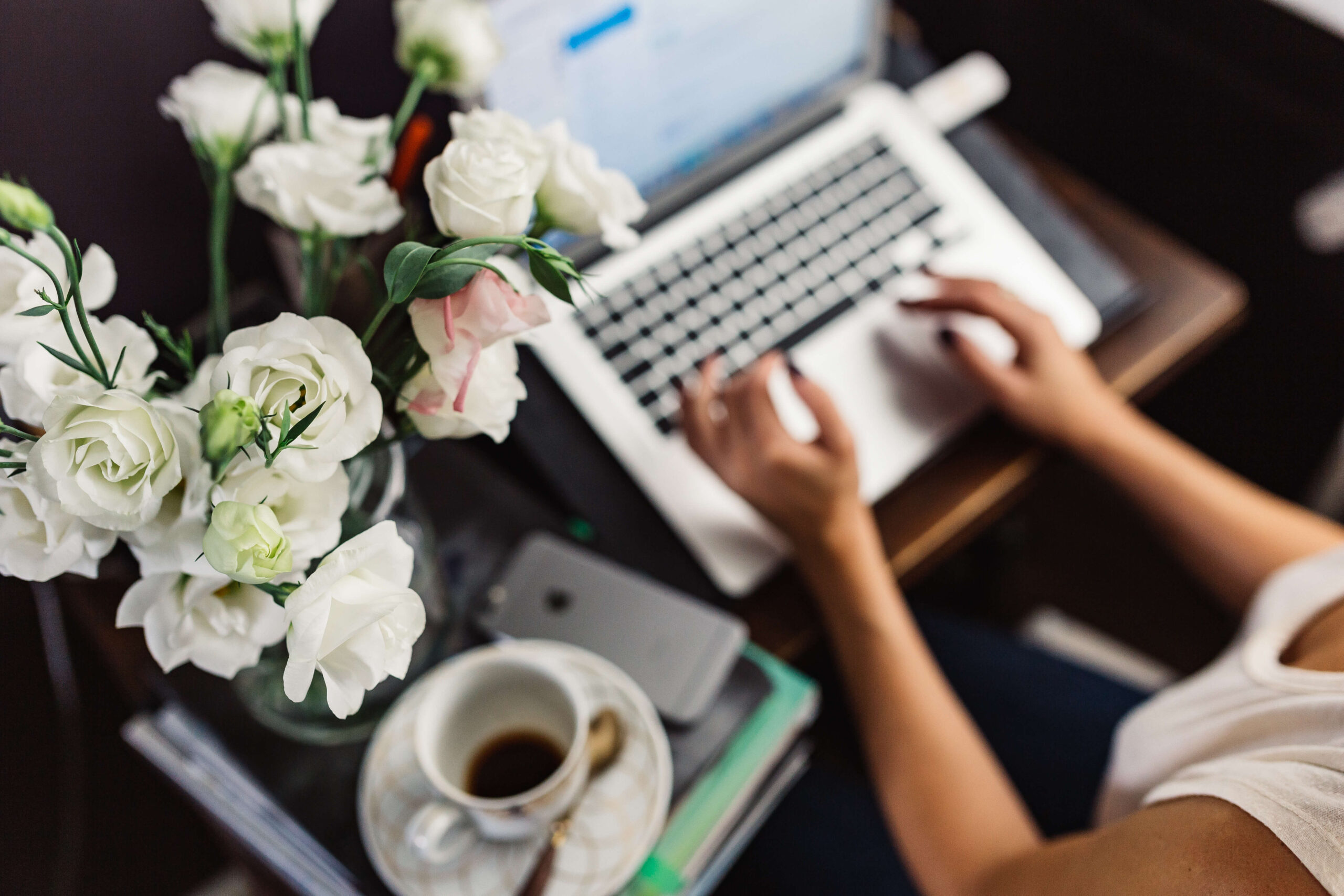 work from home outfits woman at desk with flowers