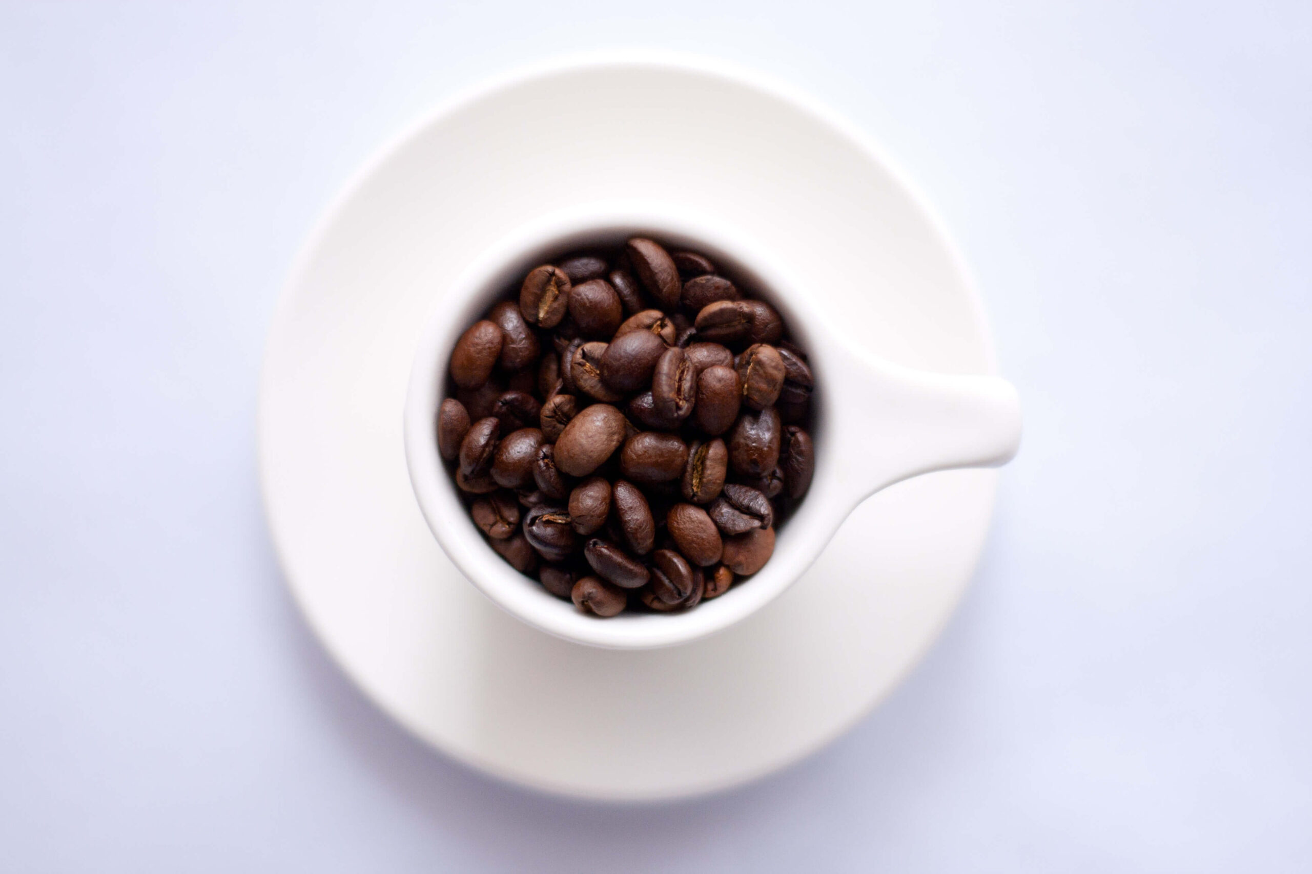 do you love coffee post with a cup of coffee beans against white background