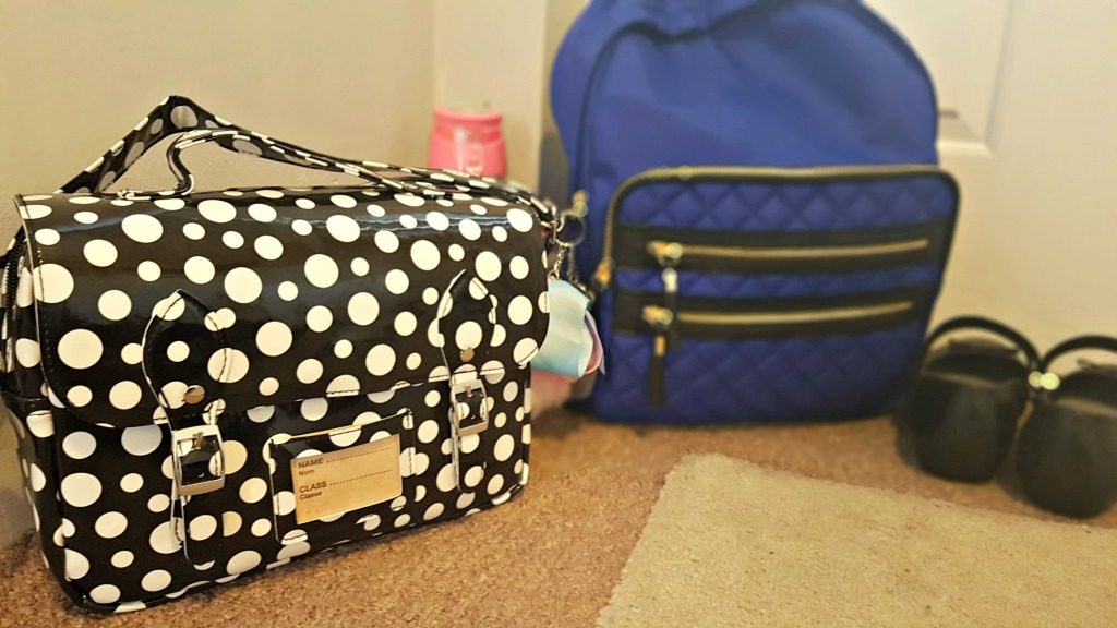 spearmark cool bag and rucksack by a door with school shoes