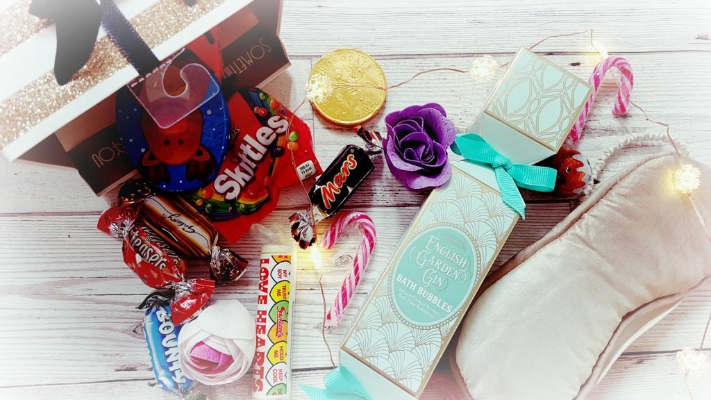christmas gift bags with sweets, chocolates, bath products and an eye mask