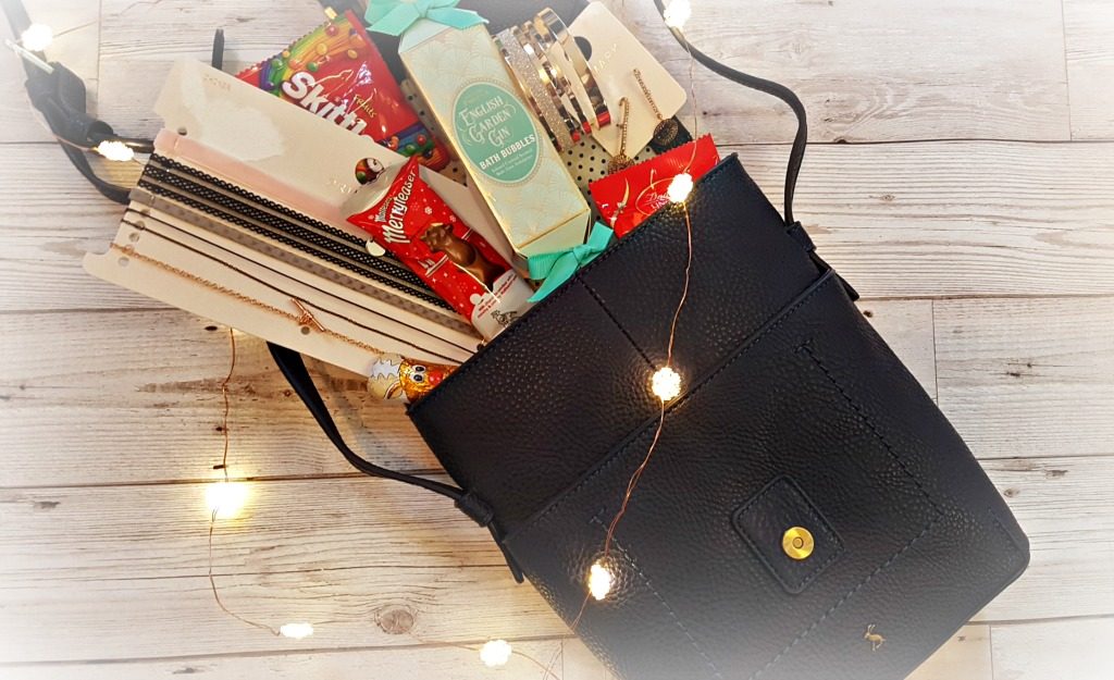joules navy cross body bag with cohoclates, bath products and jewellery with led snowflake lights