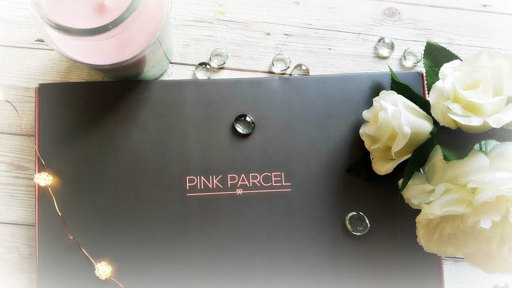 pink parcel subscription box with flowers candle and fairy lights