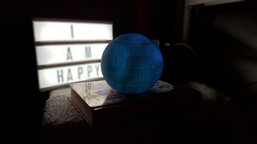 star wars death star illumimate light in front of a light box saying i am happy