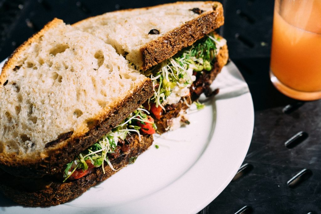 salad sanwich on grain bread on a white plate