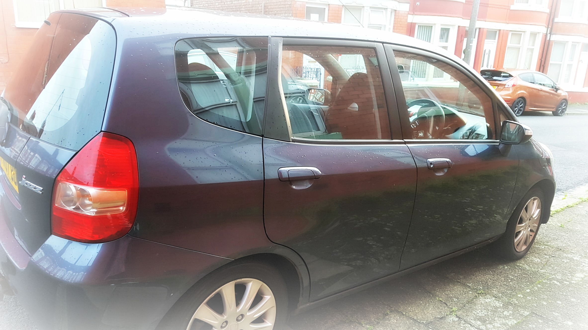 side view of a slate grey honda jazz