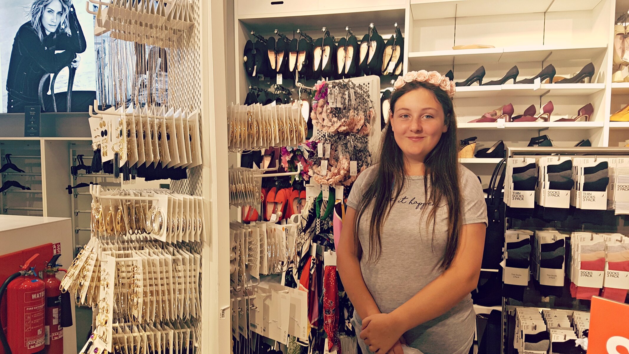young girl wearing a flower headband in a h&m store