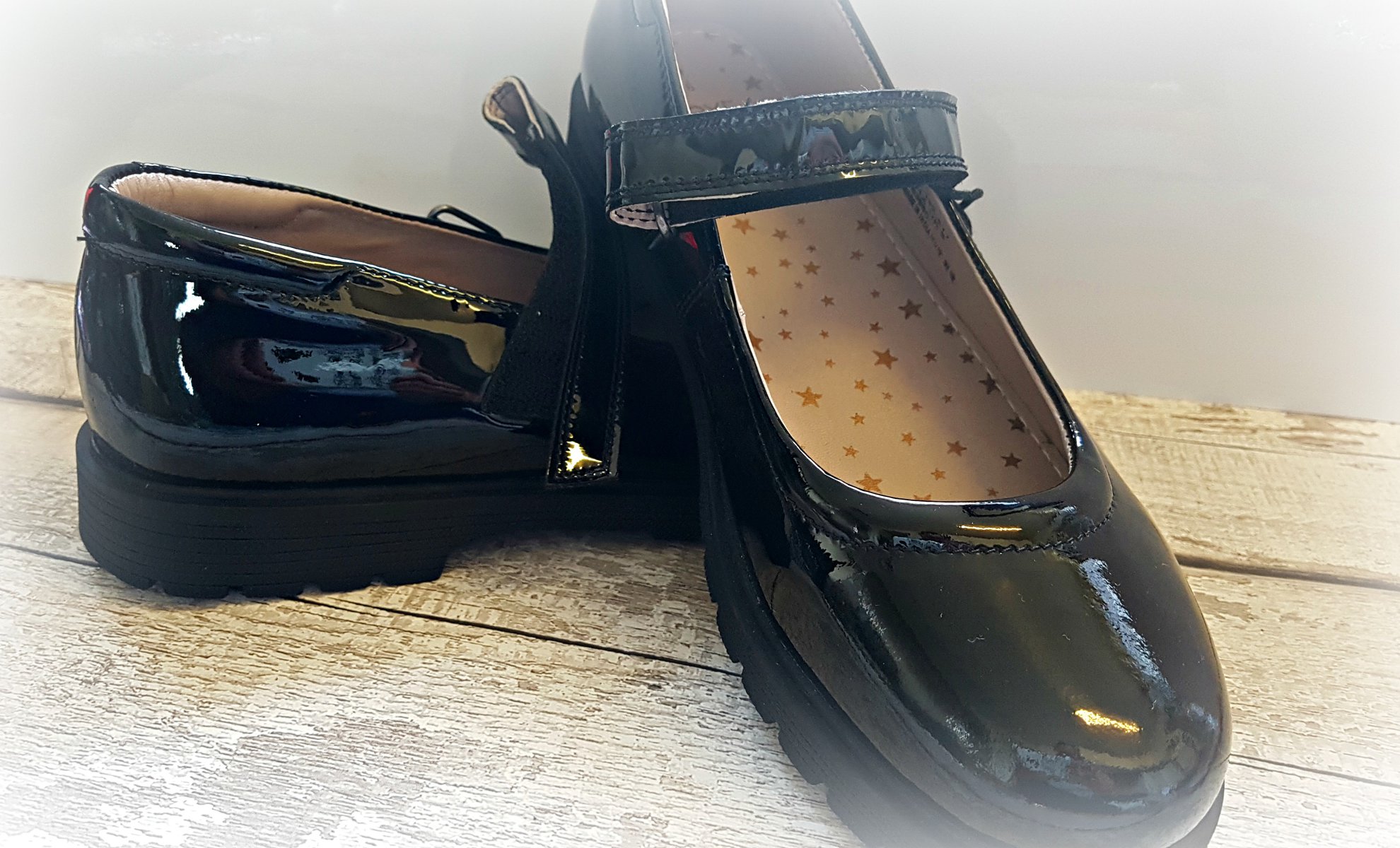 flatlay of black patent mary jane school shoes