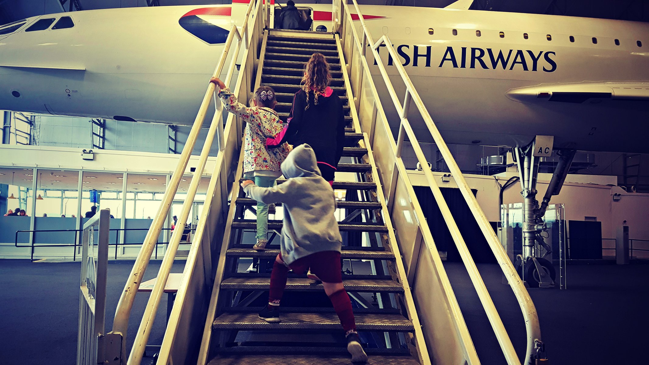 3 kids going up the staircase on concorde at manchester airport runway visitor park