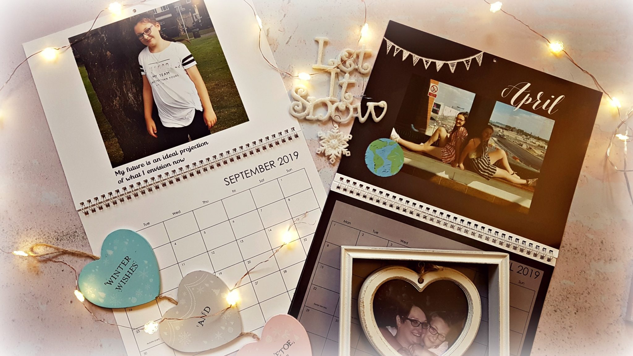 two open truprint personalised calenders with wooden heart decorations, a wooden heart picture frame and snowflake fairy lights