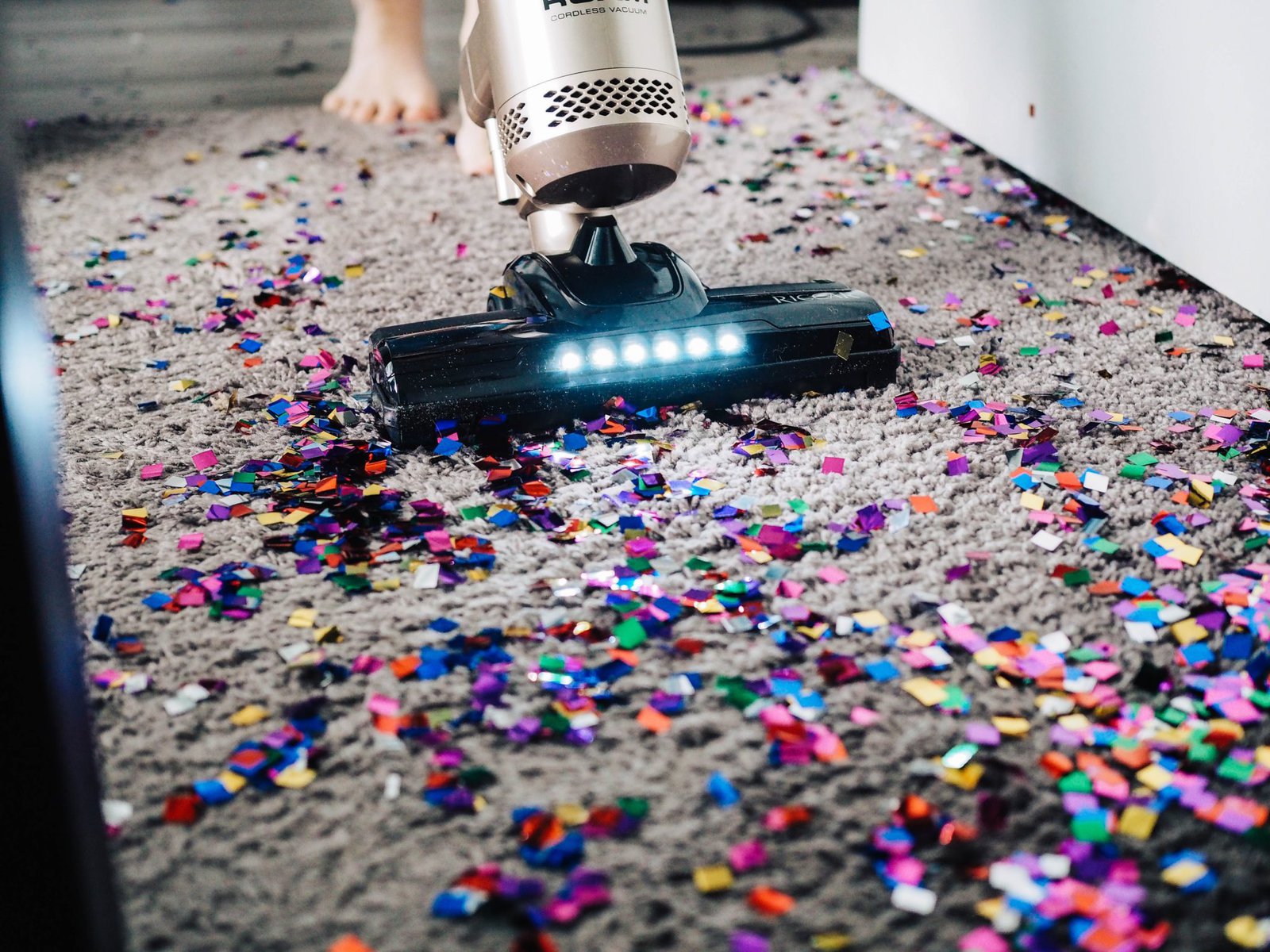 vacuum cleaning up glitter flecks from a carpet