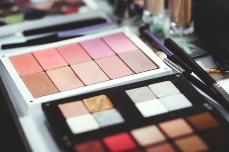 an open selection of makeup palettes on a counter