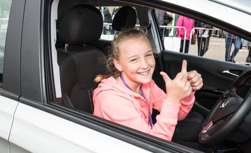 young girl in the driver seat of a csr for a young driver experience
