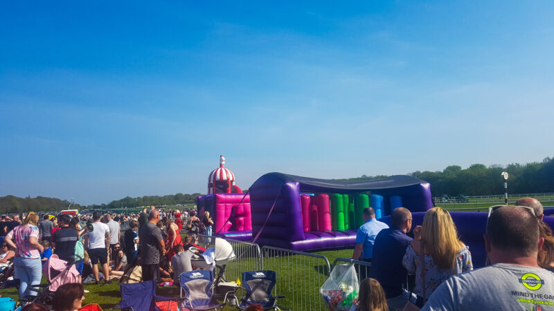 inflatable course behind rowds of people sitting down