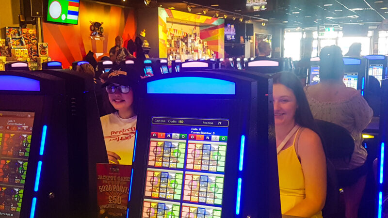 tow young girls sitting at bingo screen at coral island blackpool