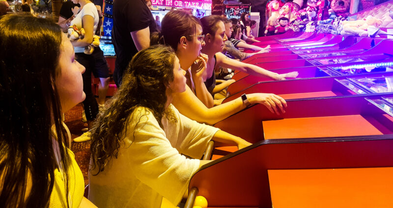 row of people sat to play camel derby at coral island blackpool