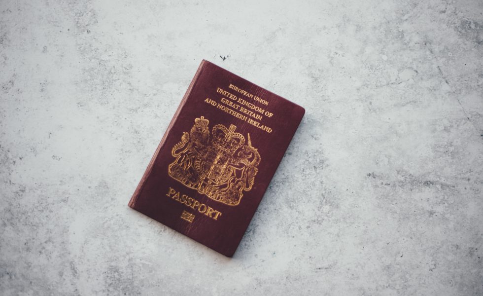 a red british passport on a backdrop