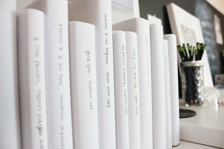 row of white books on a shelf