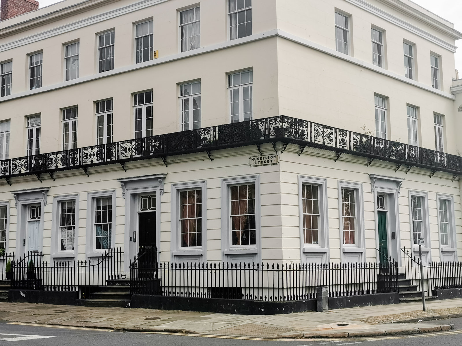 a white building on the corner of a street in liverpool city centre
