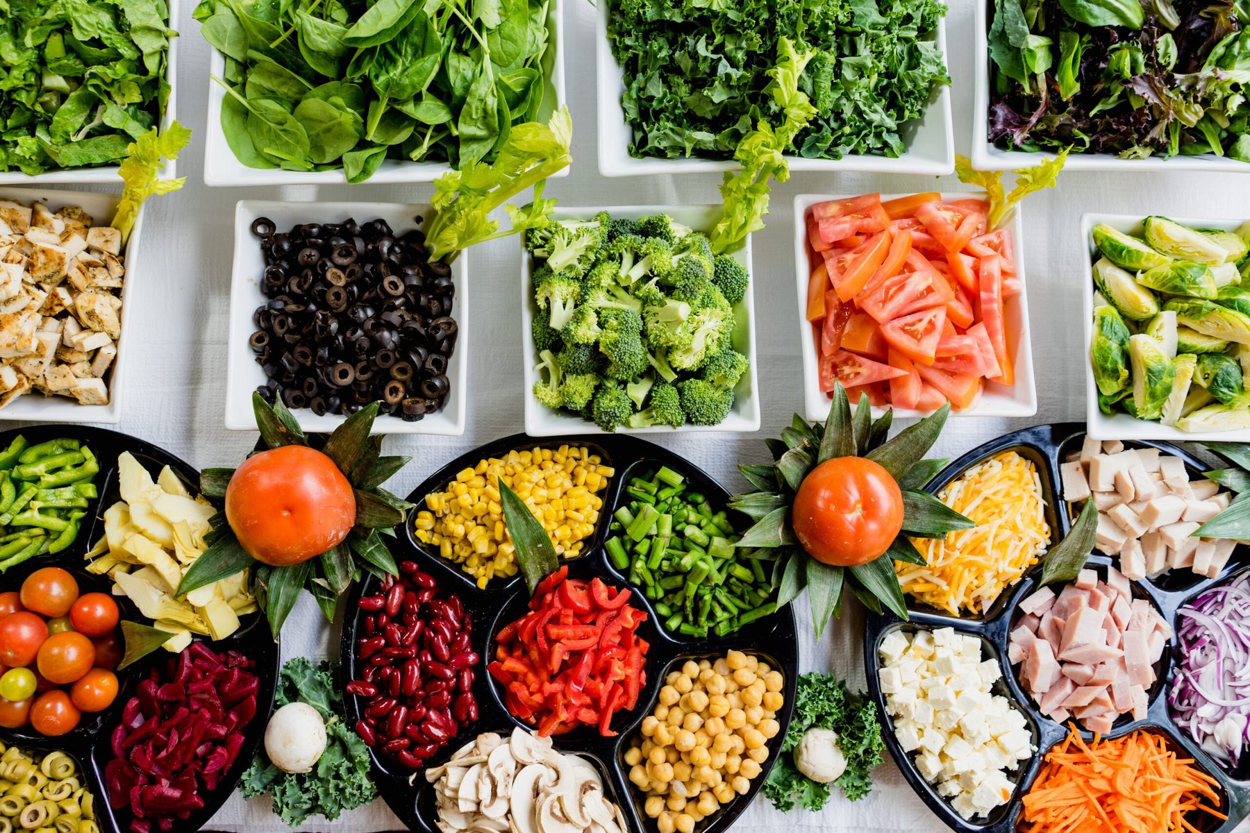 an overhead shot of a selection for fruits and vegetables in bowls
