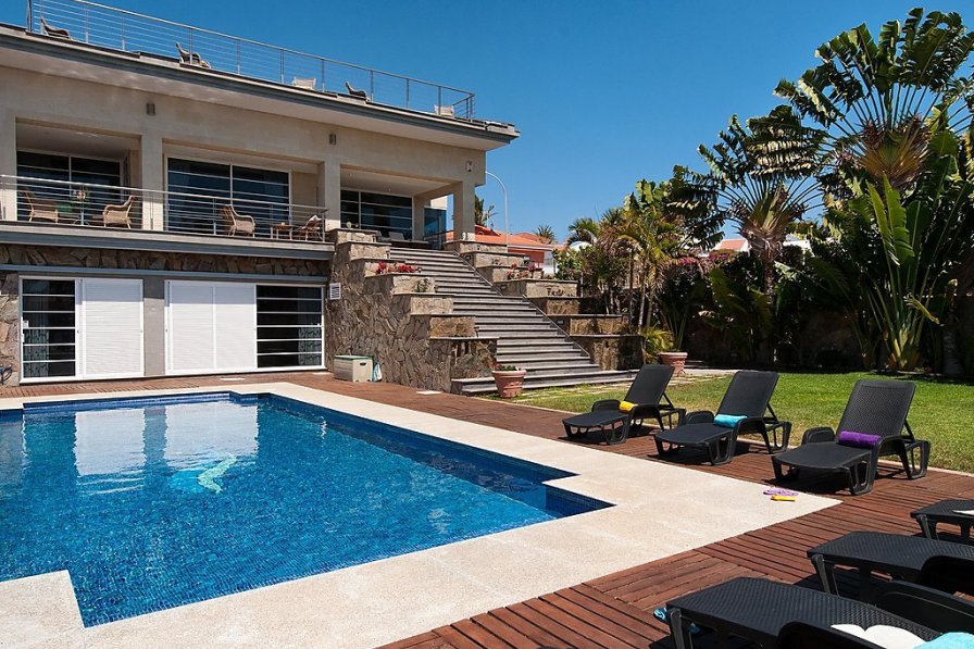 outside shot of a villa with a private pool and sunbeds around the edge of pool