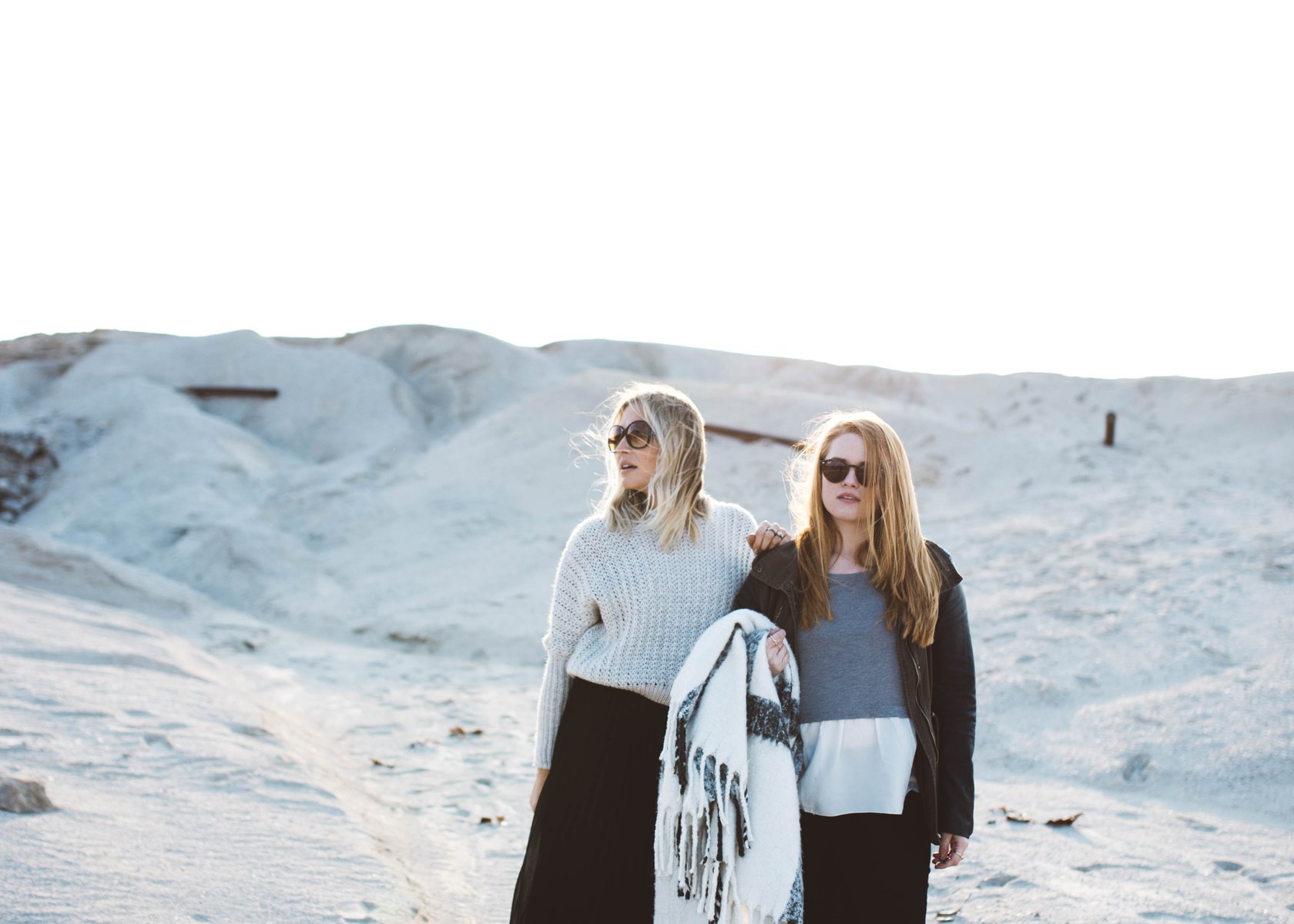 two women standing in a desert area