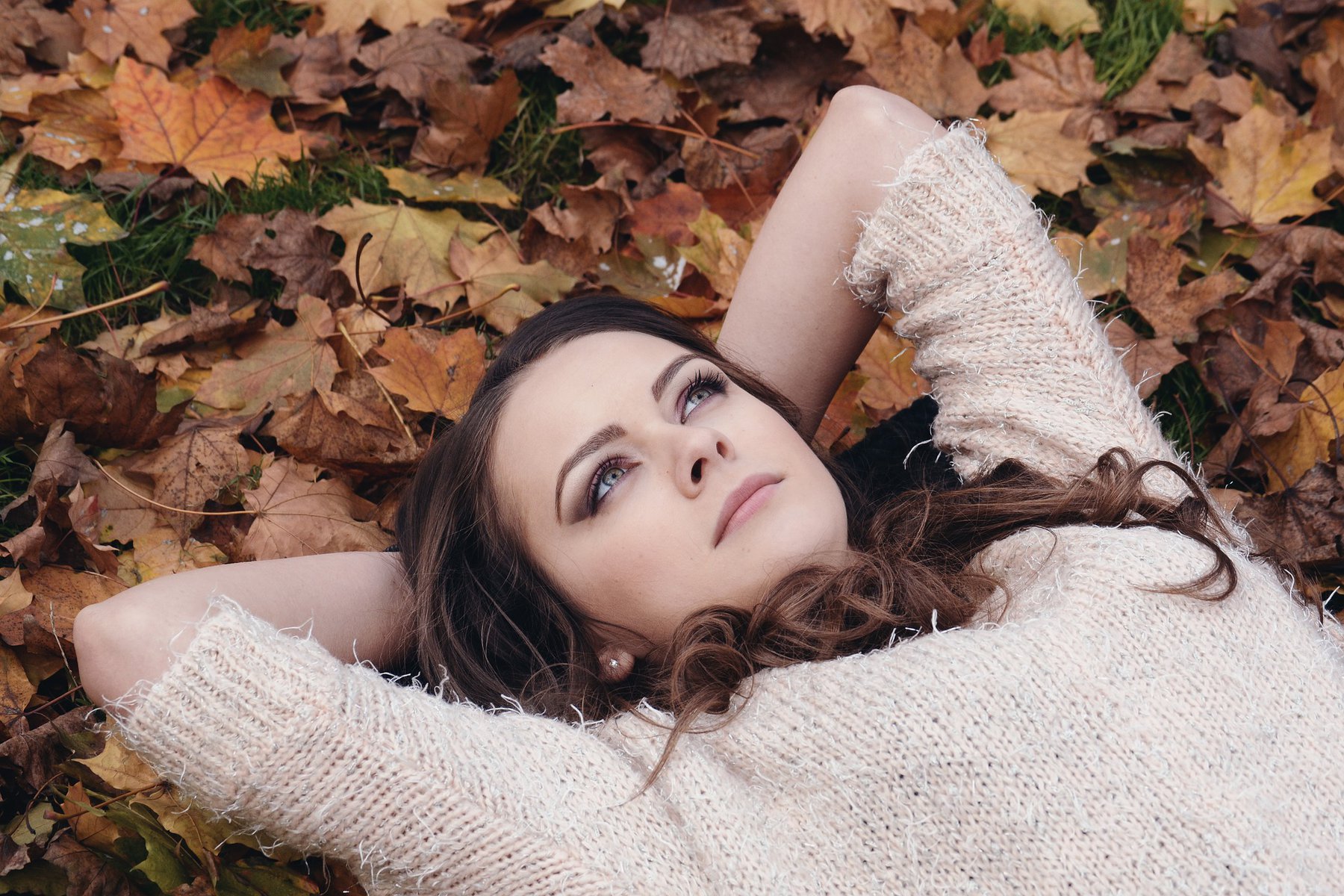 woman lying down on leaves