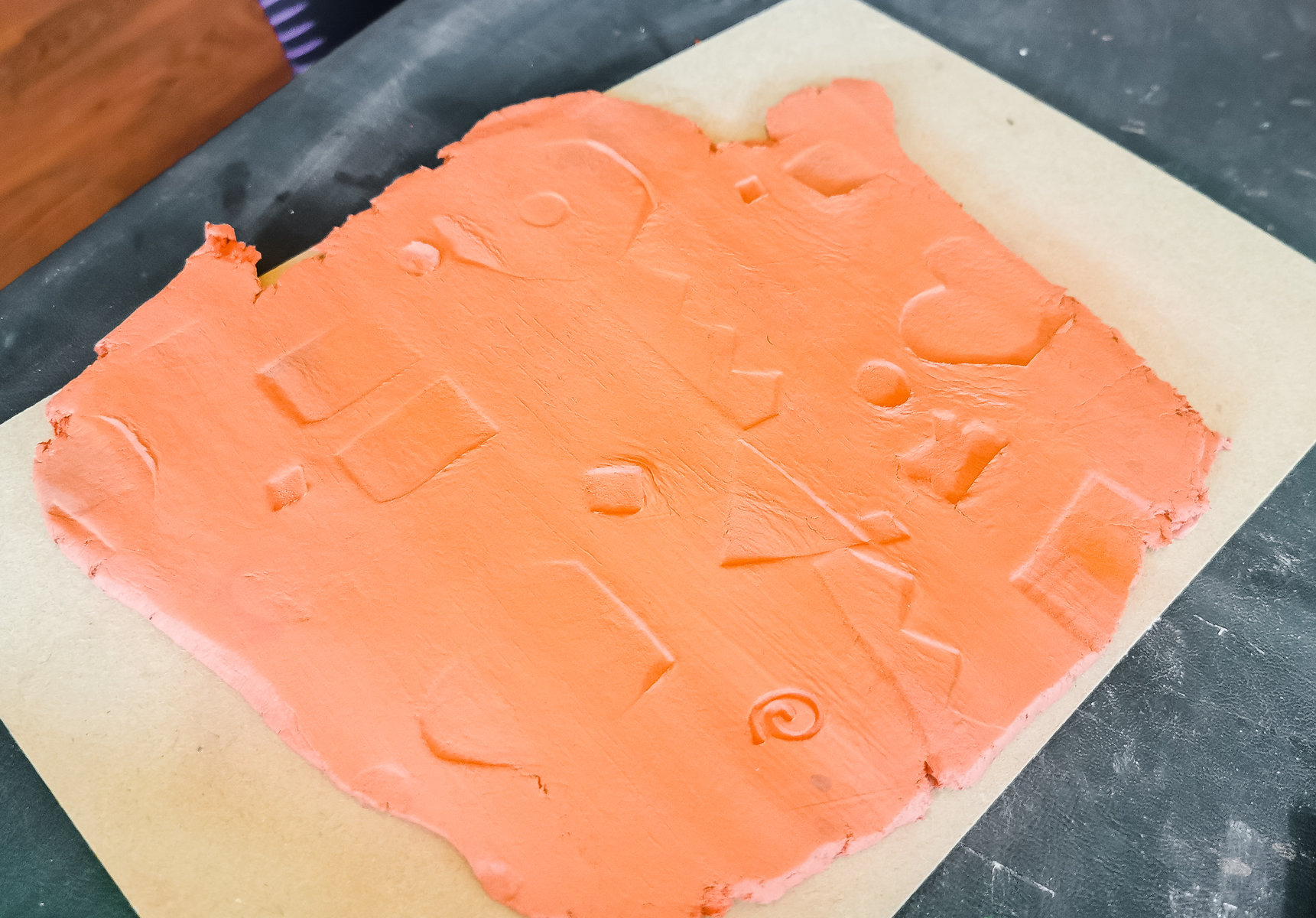 shapes pressed into brown clay