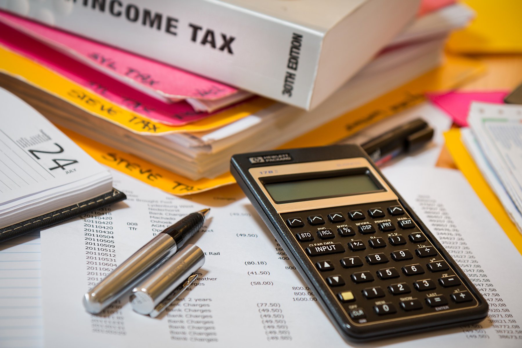 income tax book with stationery around it