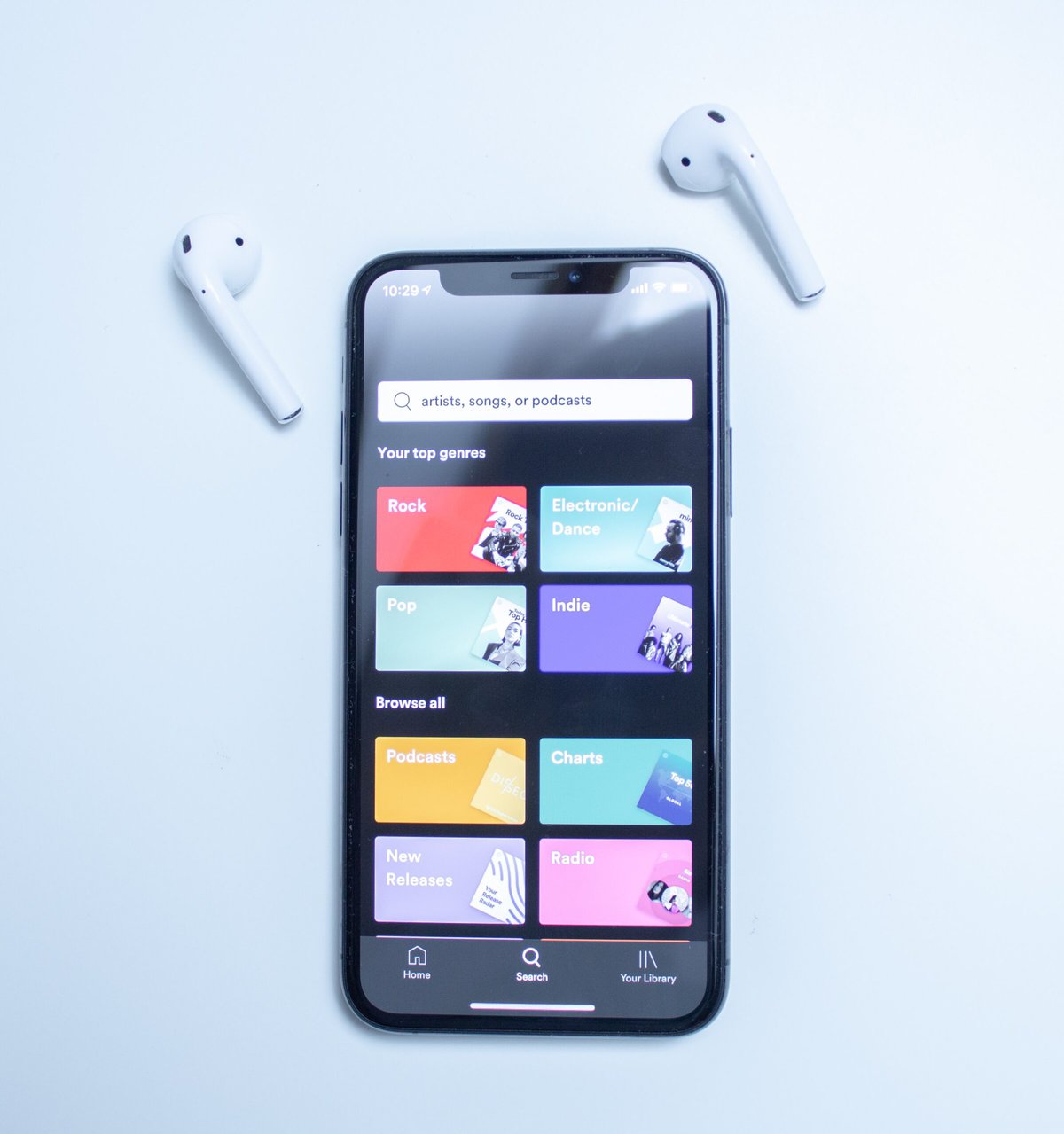 mobile phone with air pods on a white background