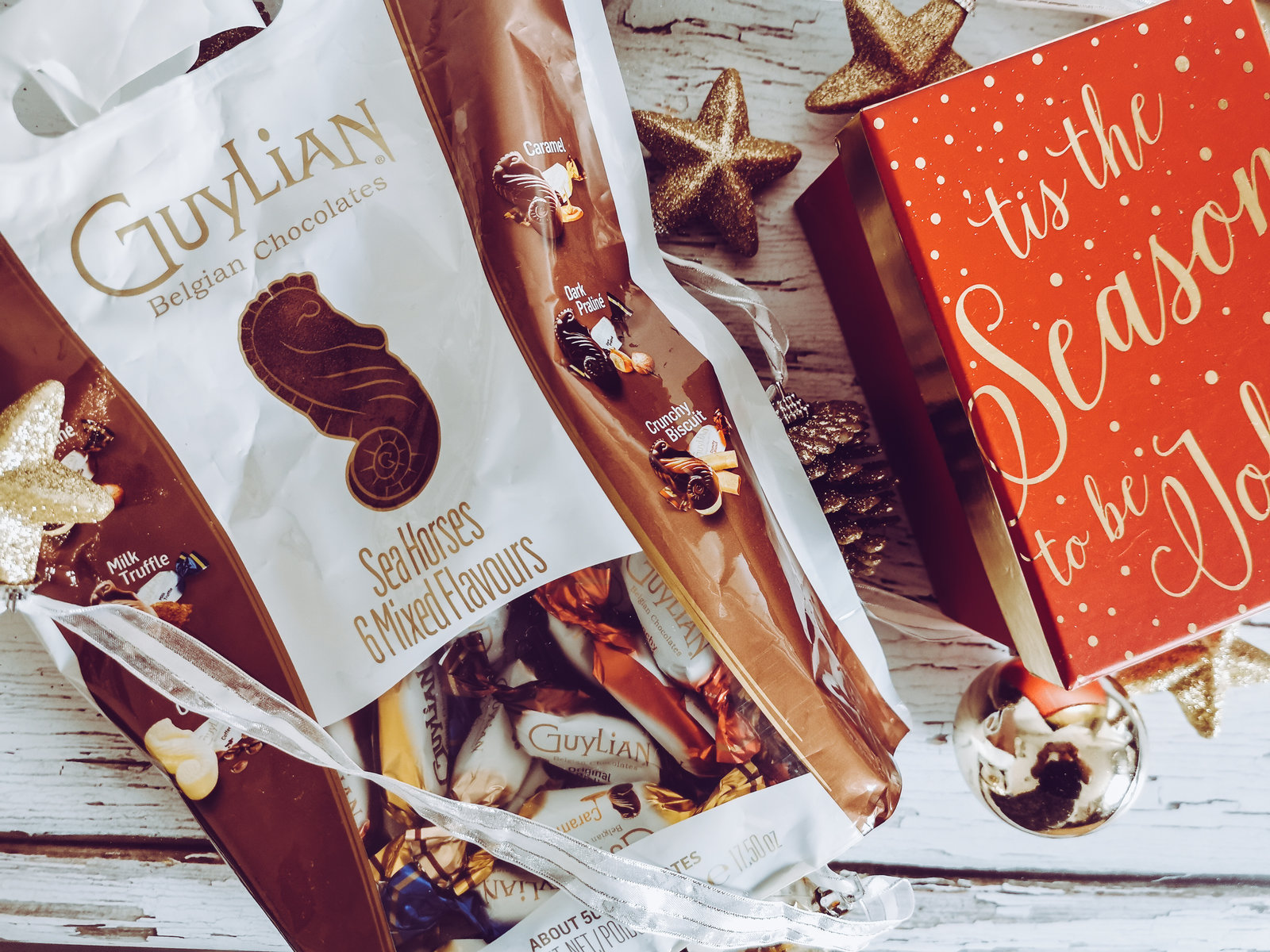 a bag of guylian chocolates in a christmas themed flatlay