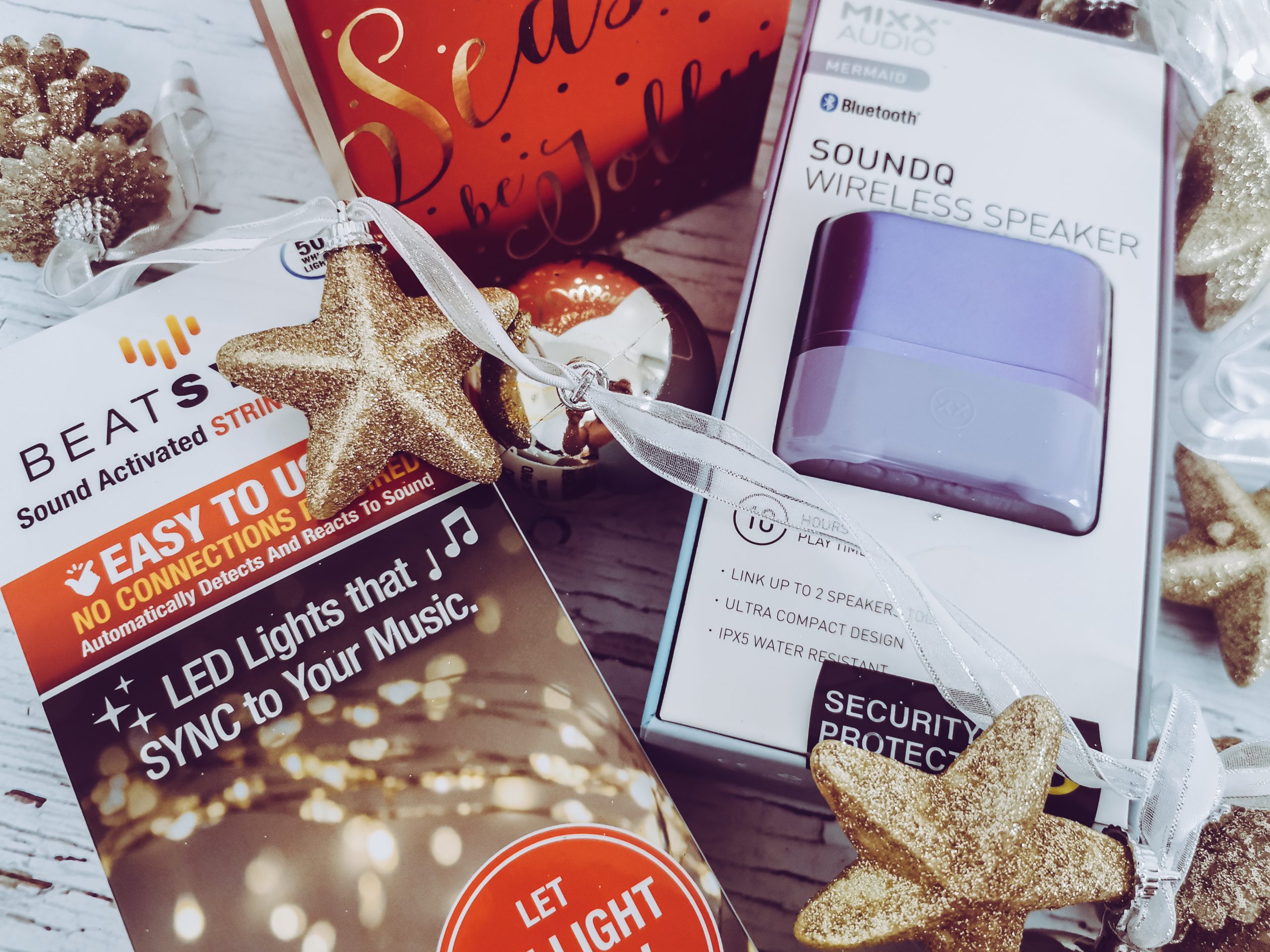 a flatlay image of music controlled lights and a bluetooth speaker