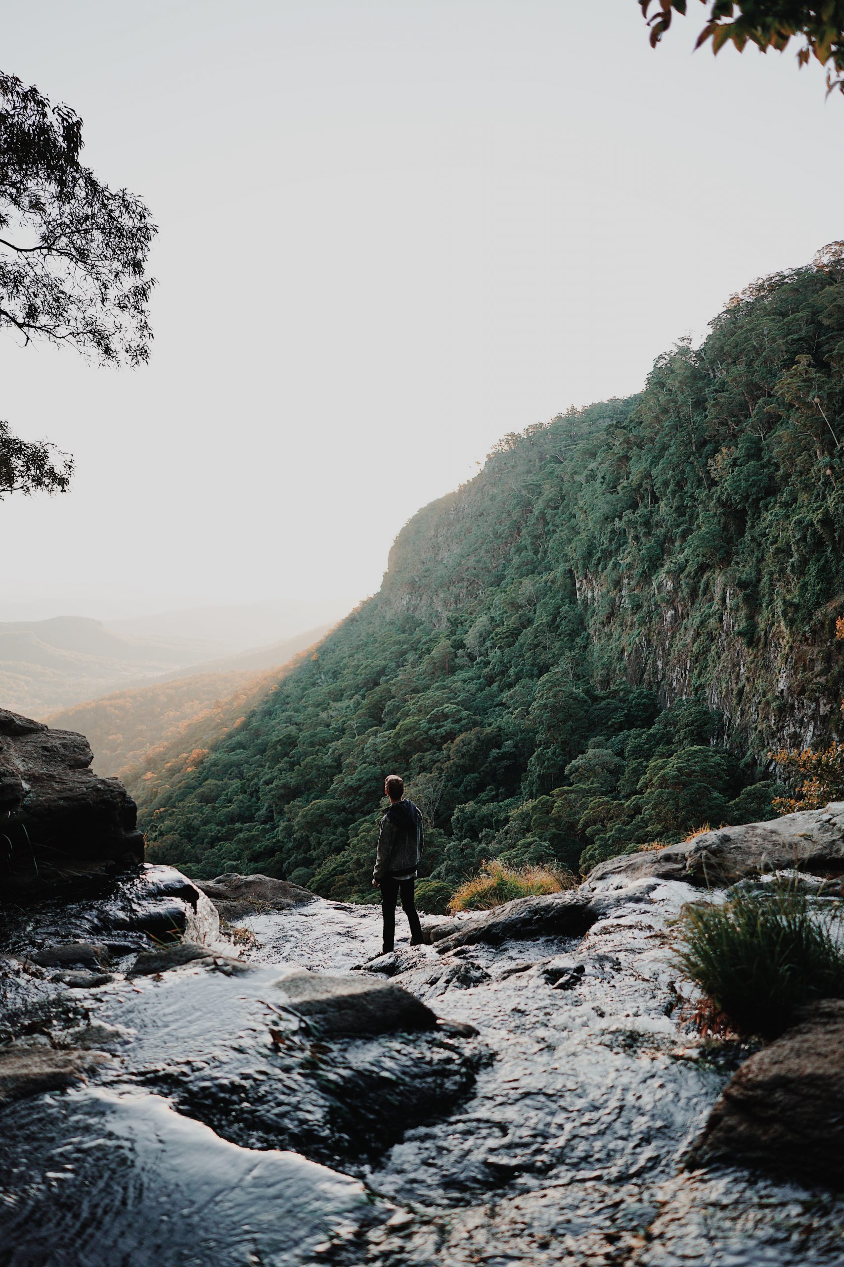 A man standing on top of a waterfall