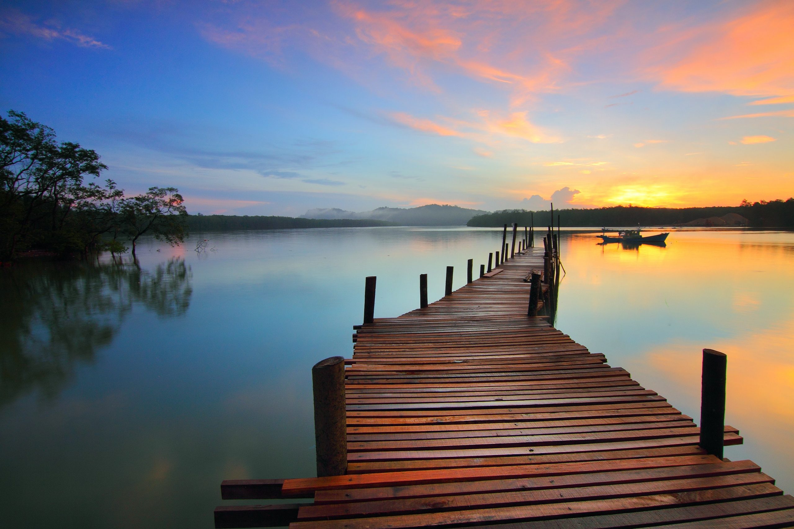 a long dock in a sunset