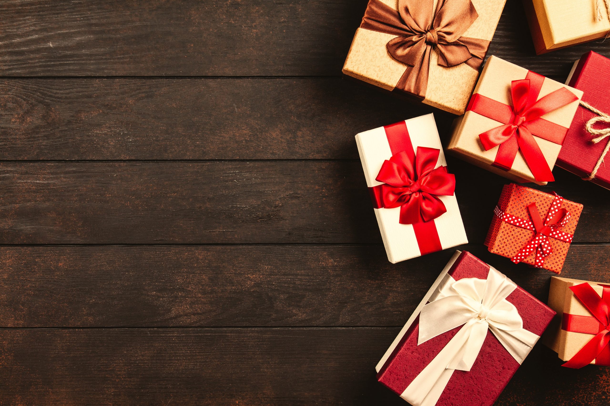 wrapped gift boxes on a wooden background