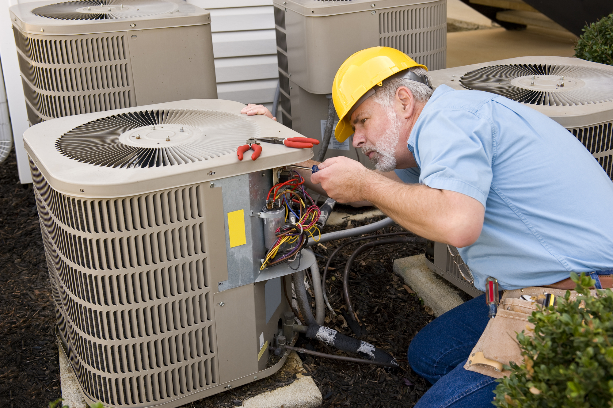 man fixing a hvac unit