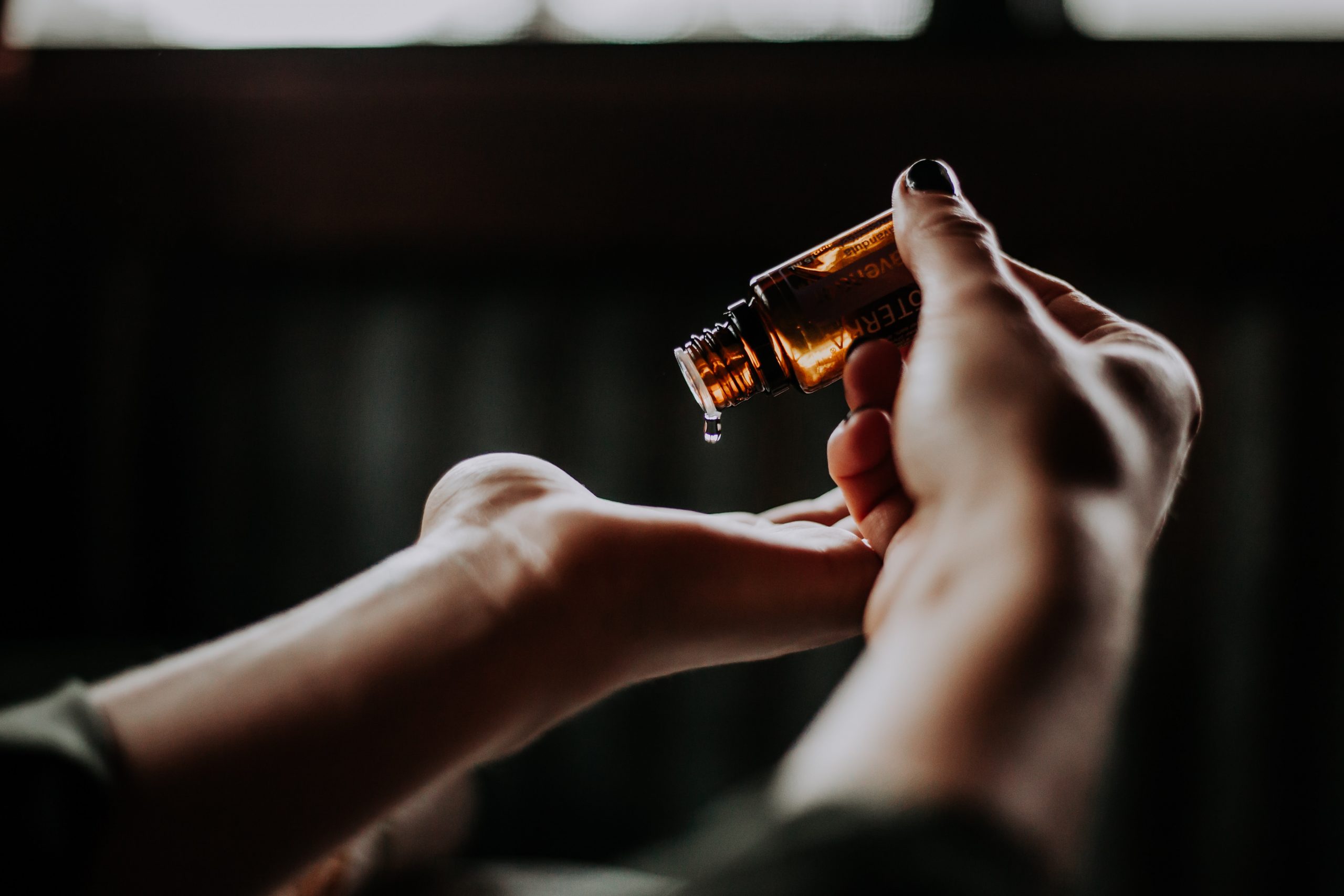 bottle with contents dripping onto hands