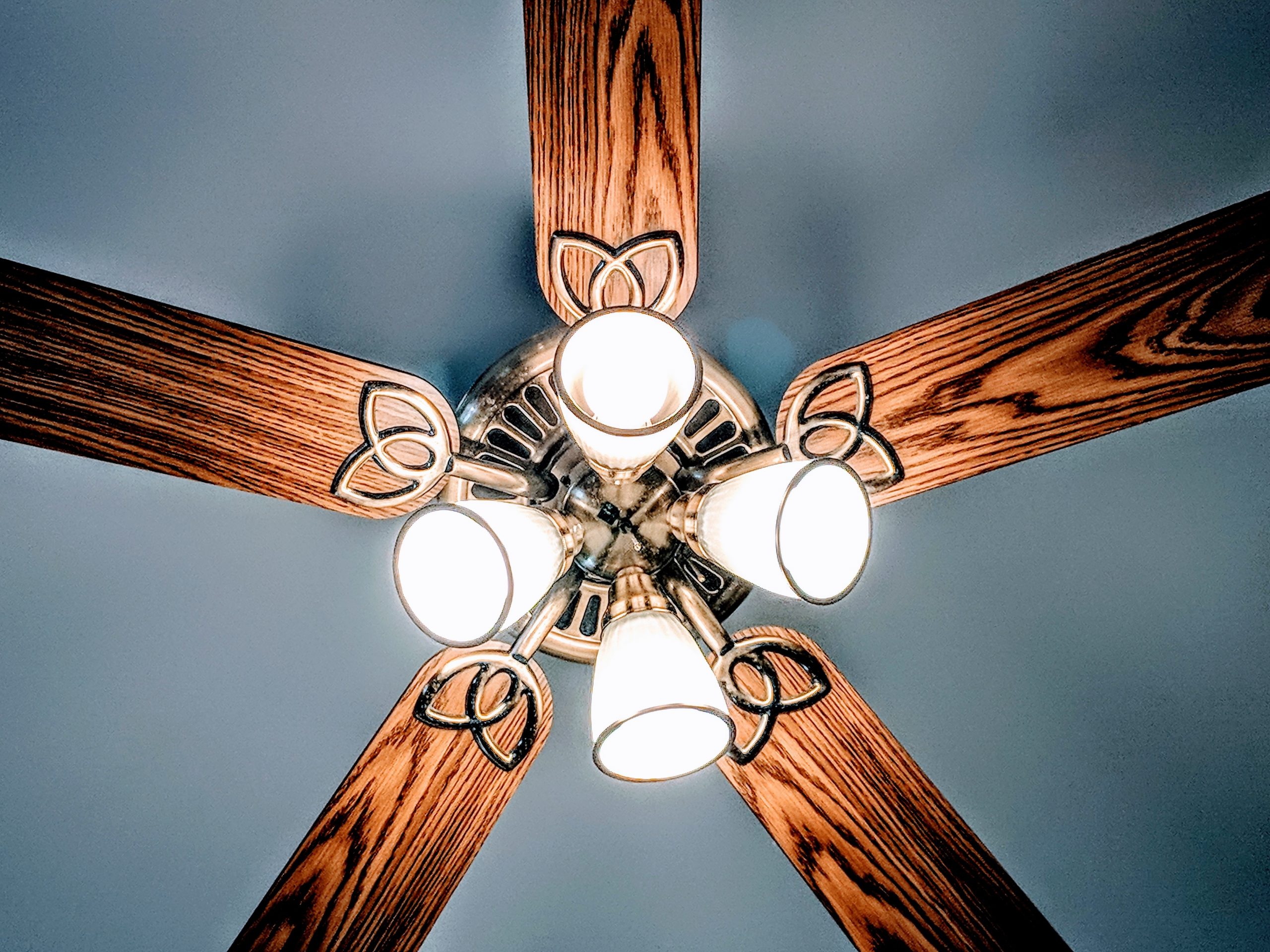 a lit brown and grey ceiling fan