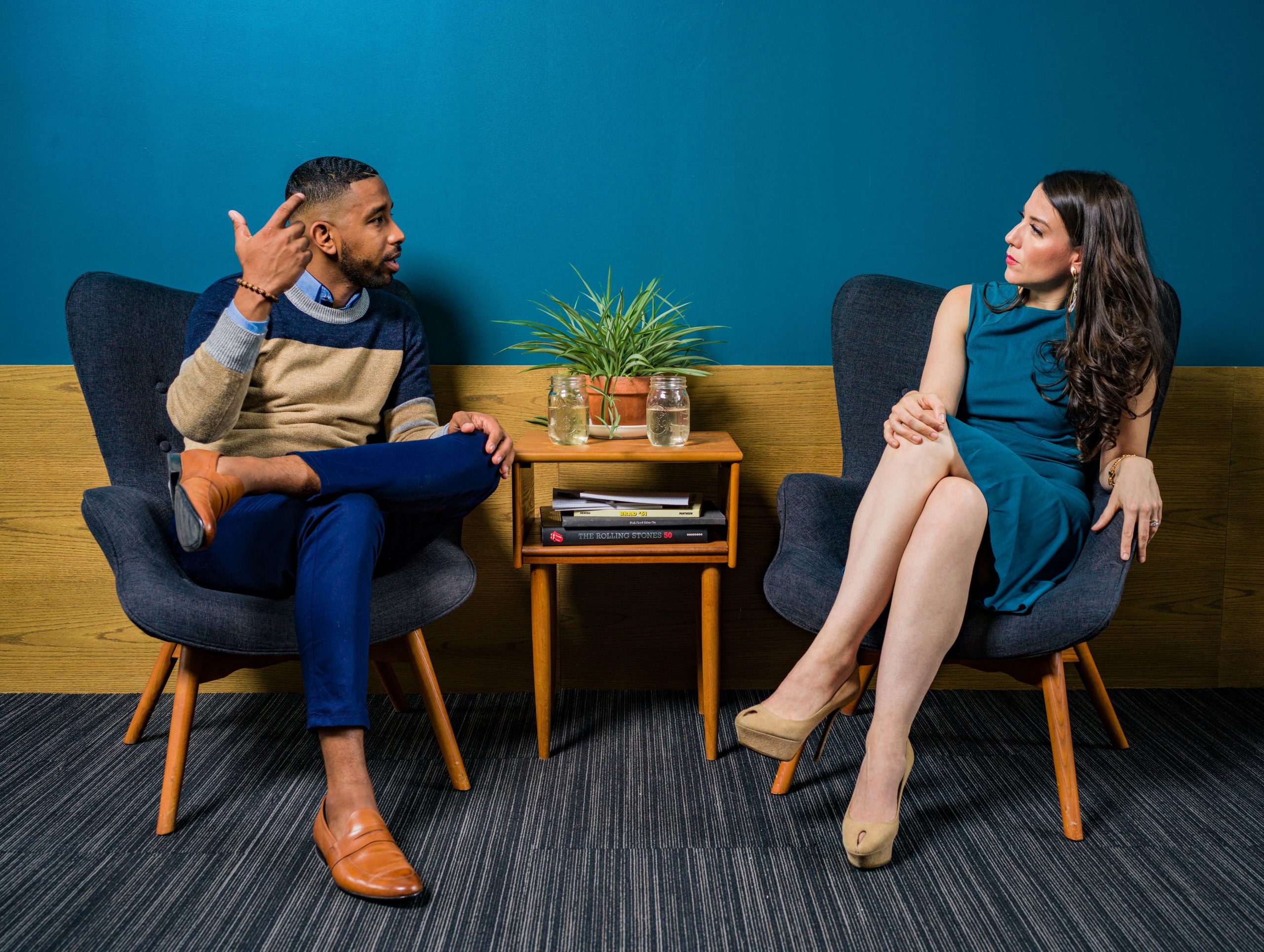 man and womaan sat around a table talking