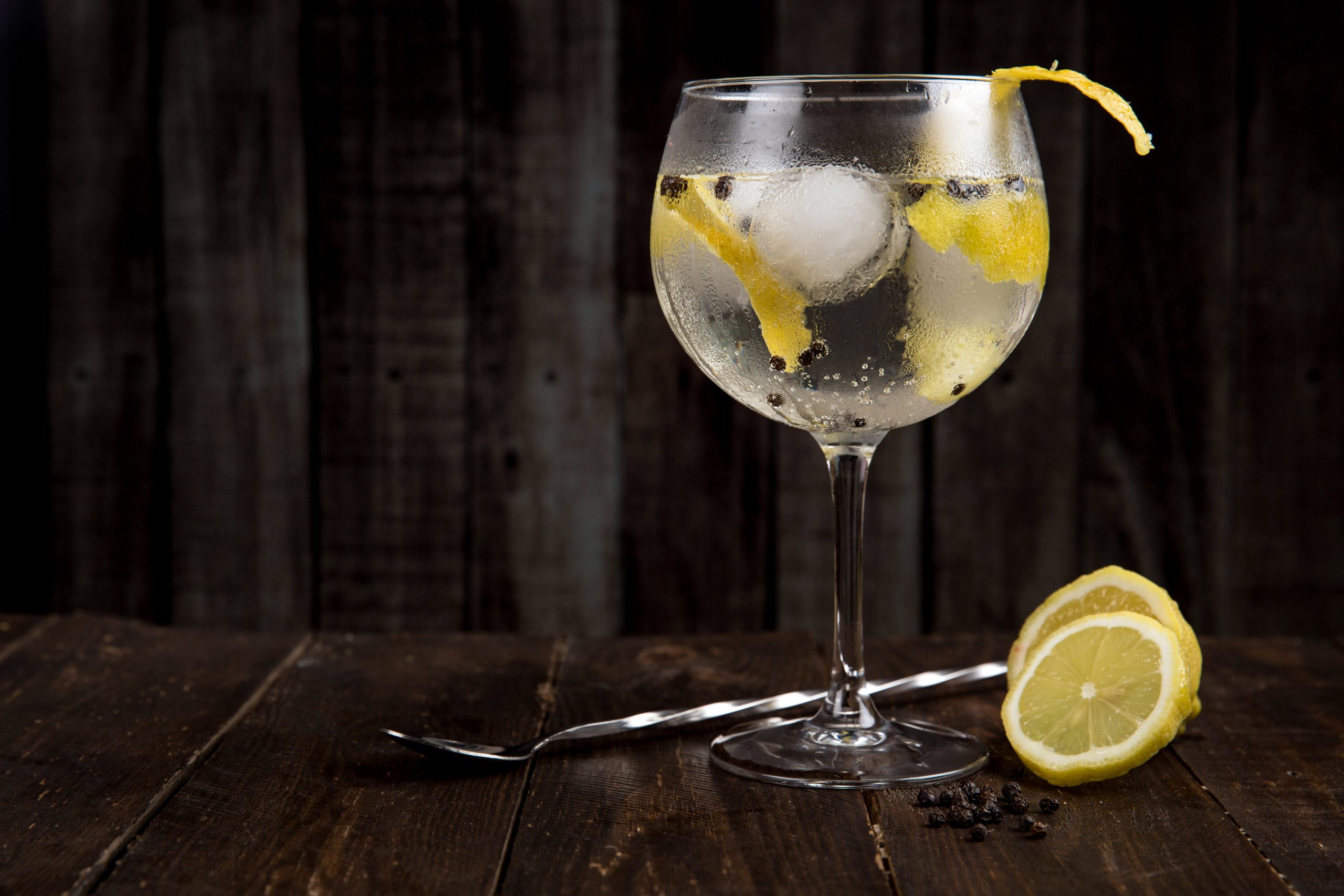 blurred image of a gin cocktail on a black background