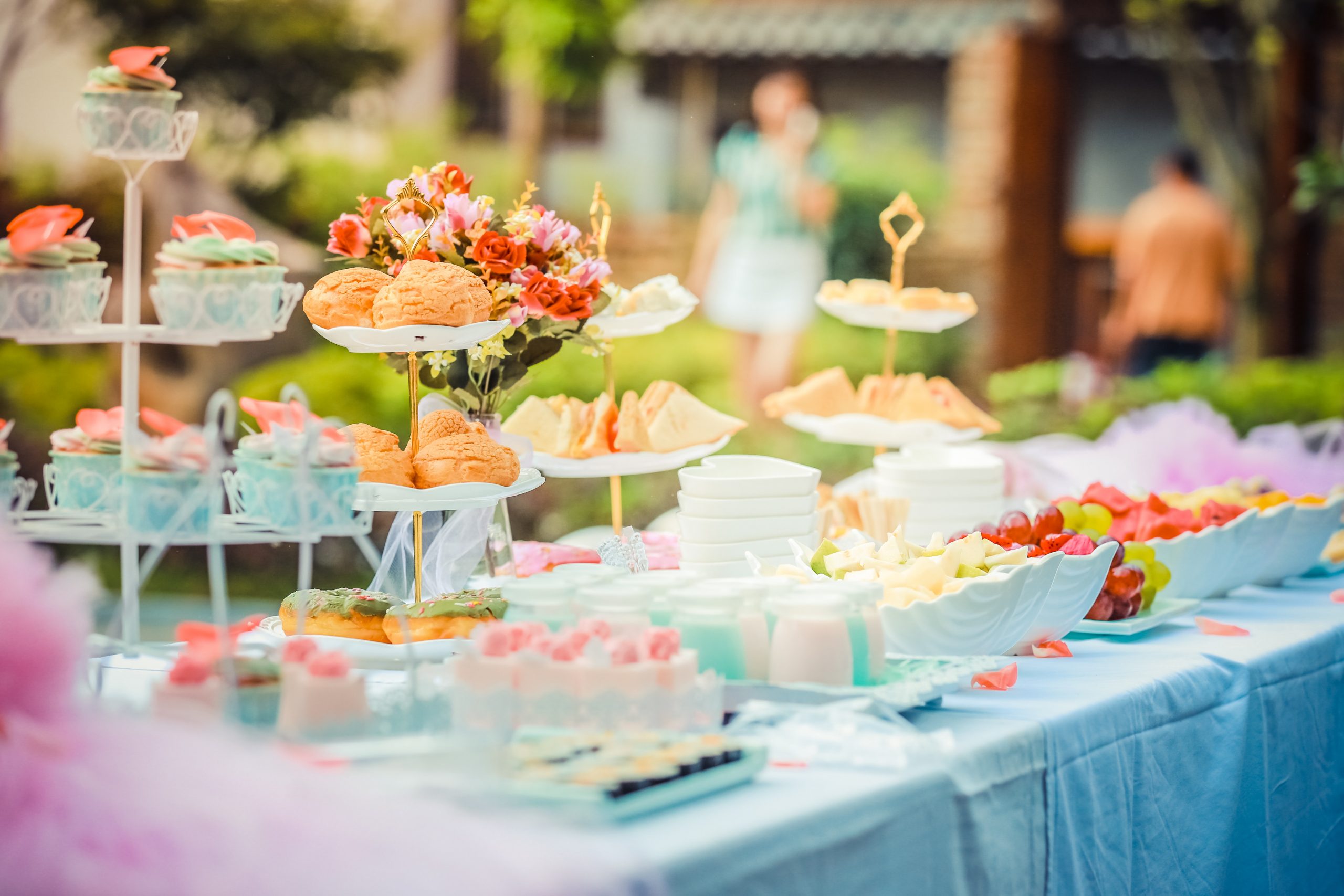 out of focus shot of a table set up with party food