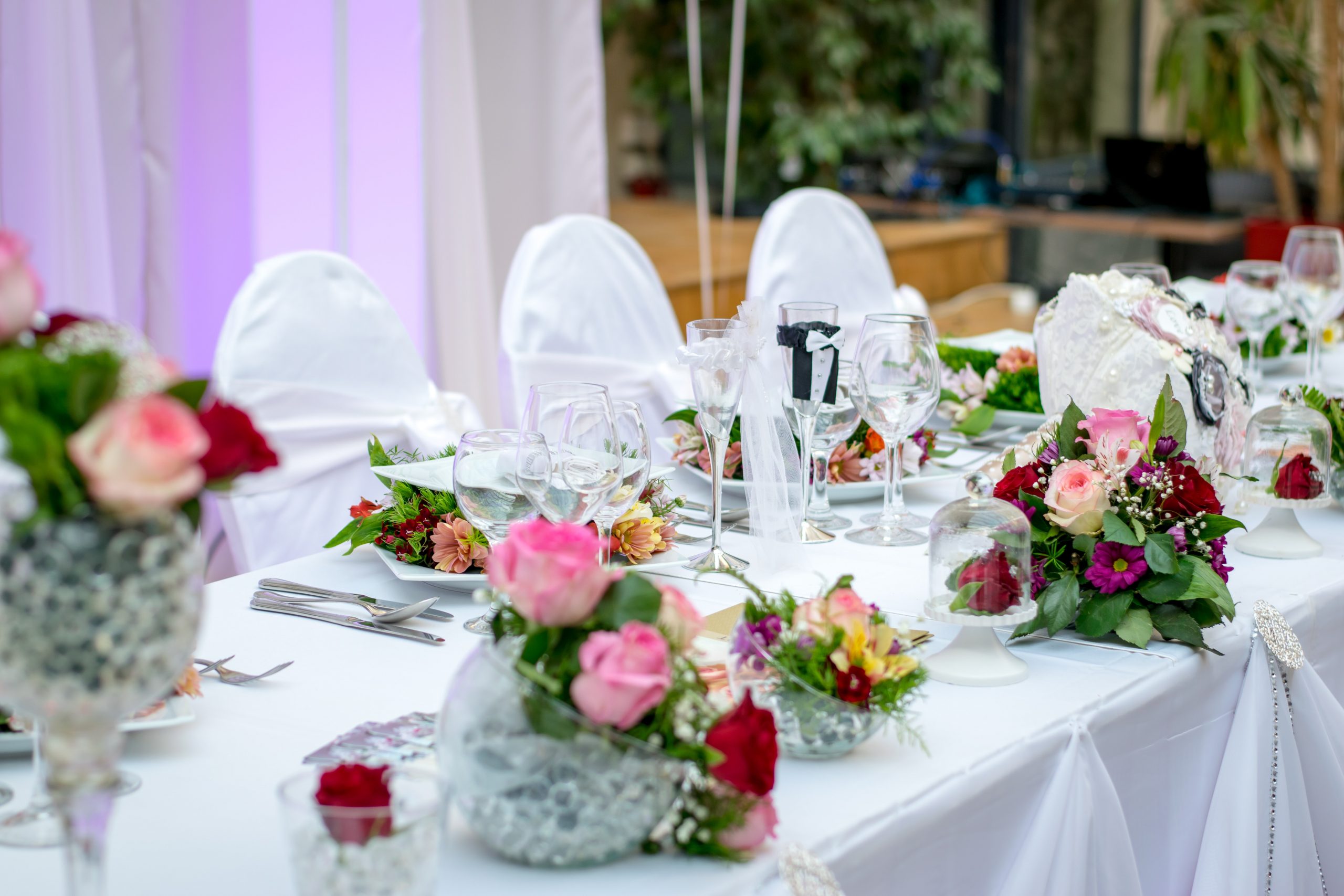 a dressed up table for a party with flower arrangements