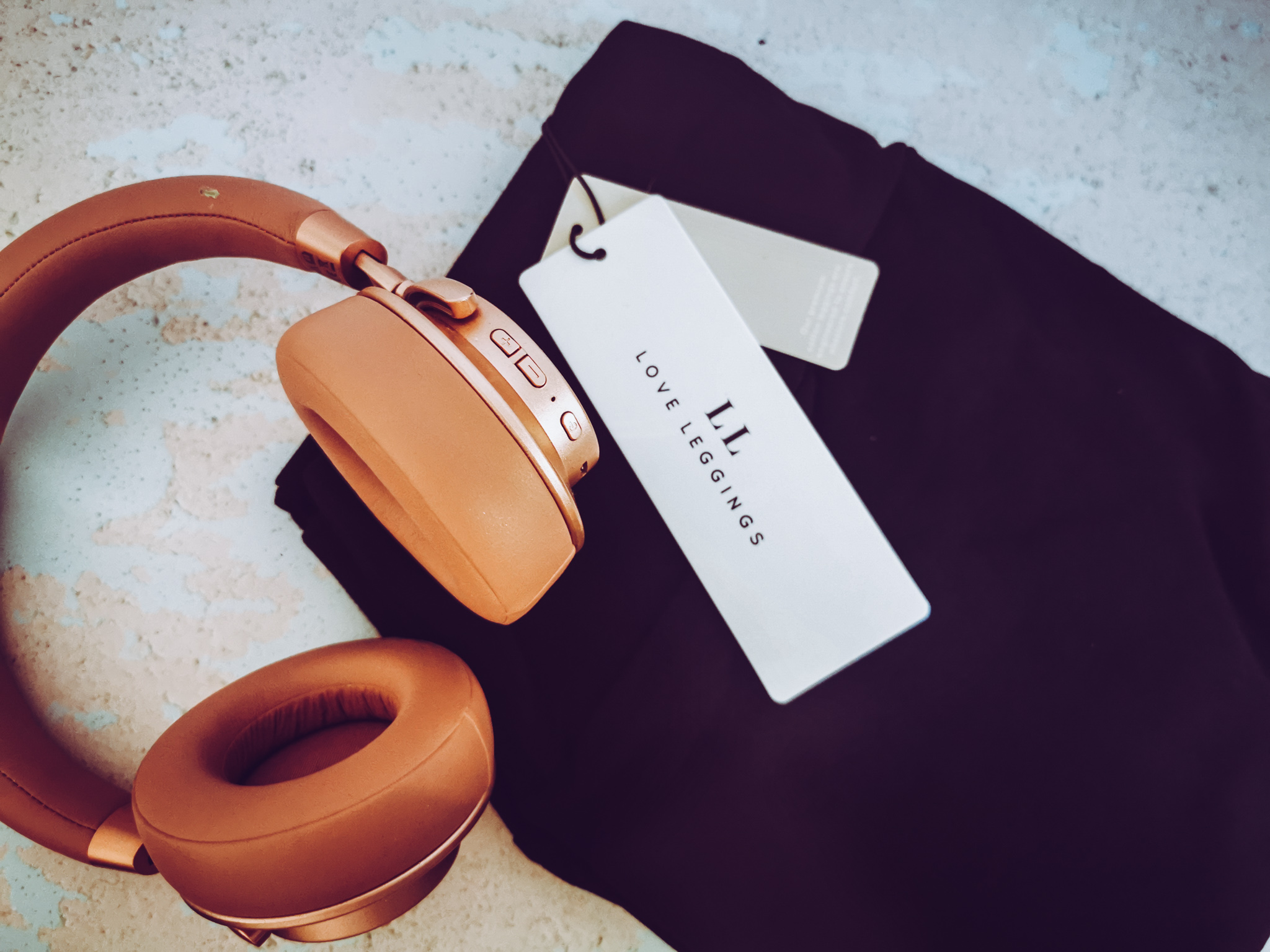 black leggings and pink headphones