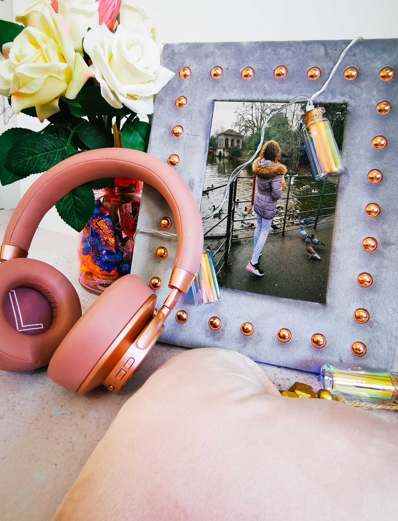 grey photoframes with flowers and headphones