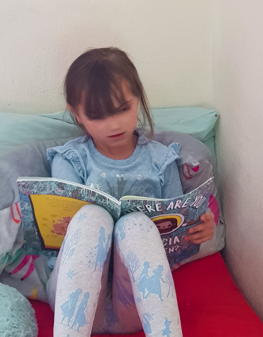 young girl reading a wonderbly book