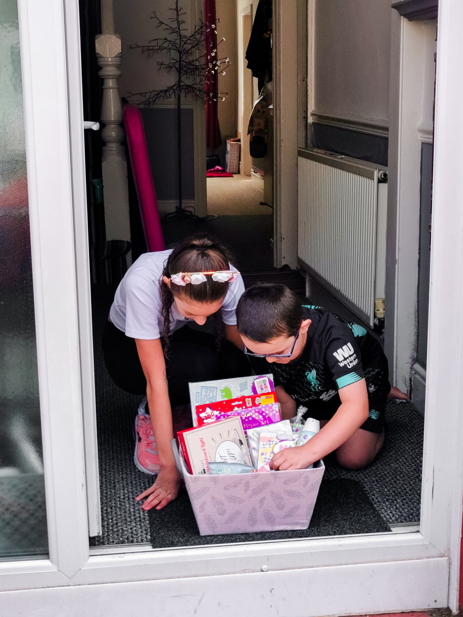 two children leaning over a gift basket